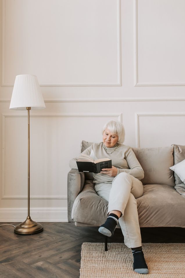A resident reading quietly in her own room
